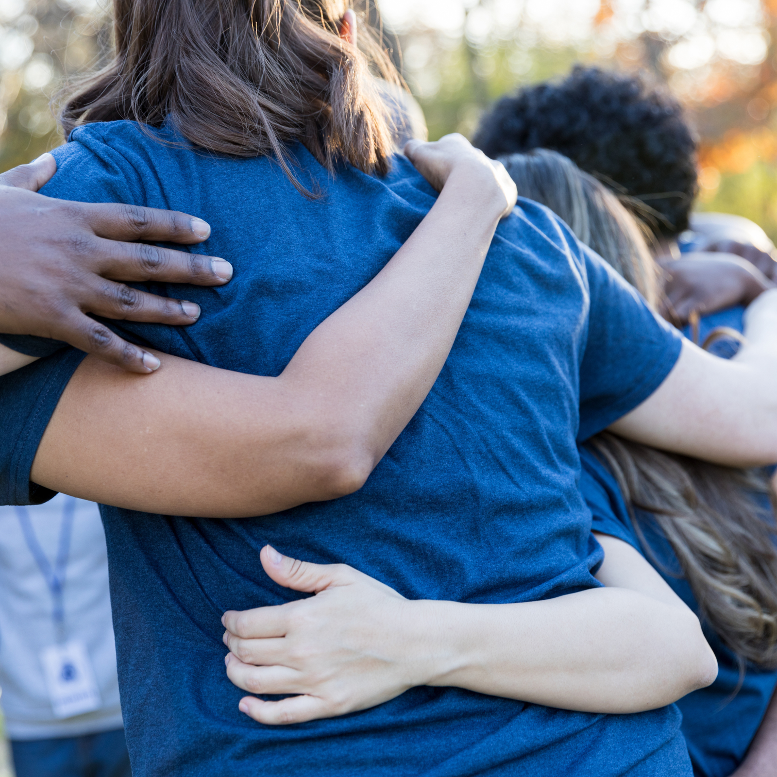 Children's hands stacked together in a gesture of unity and teamwork