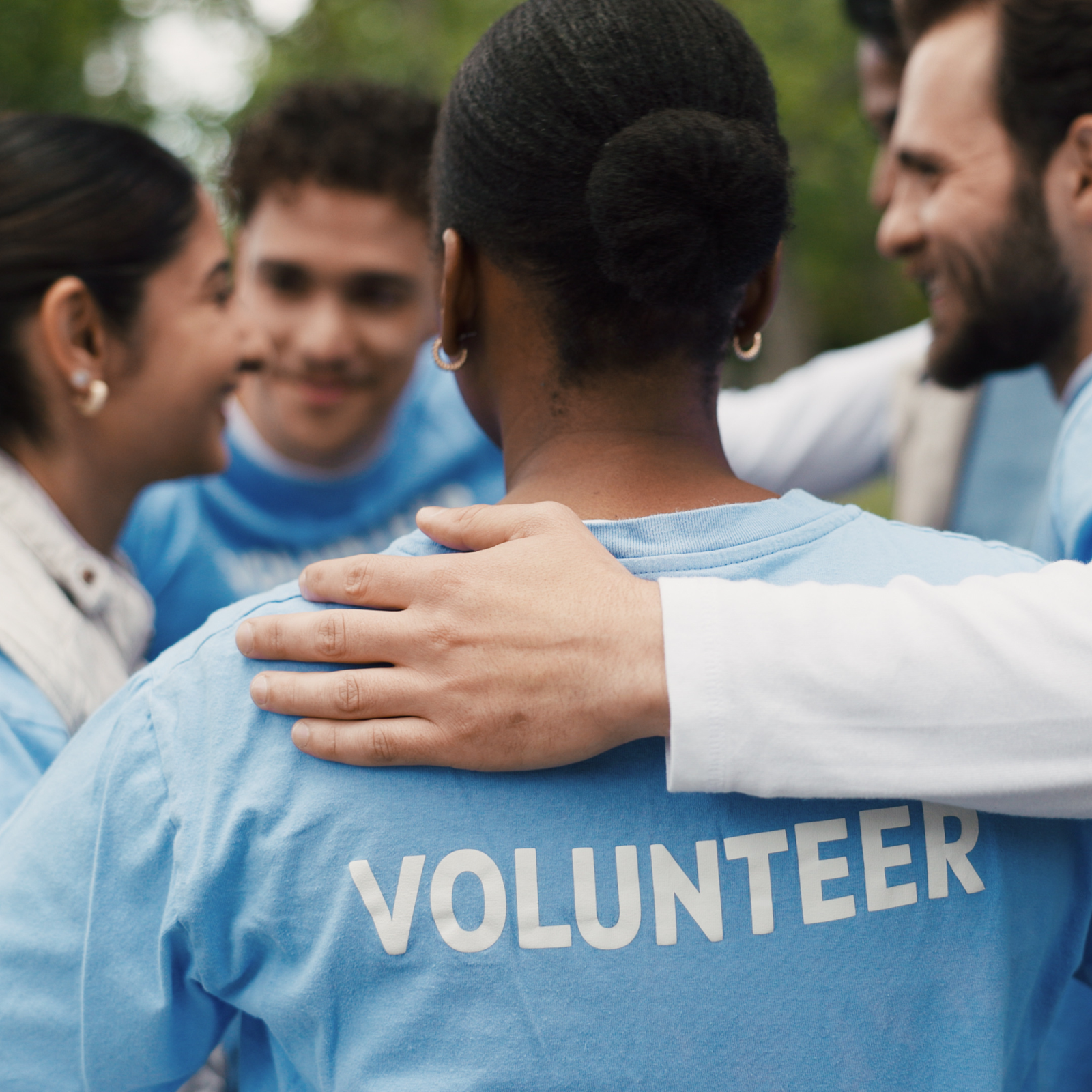 Volunteers in light blue shirts showing camaraderie and support