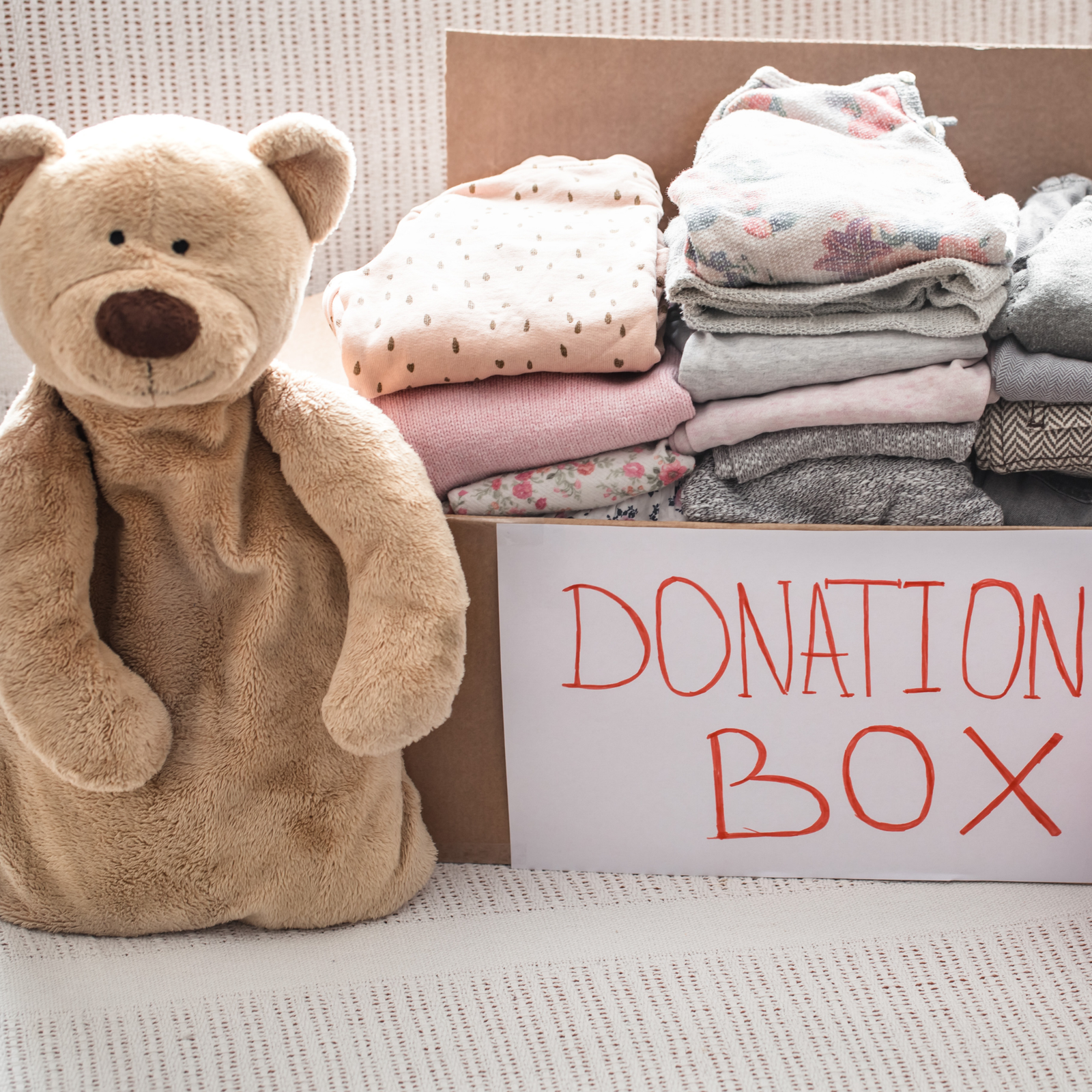 Diverse group of volunteers in light blue shirts huddled together
