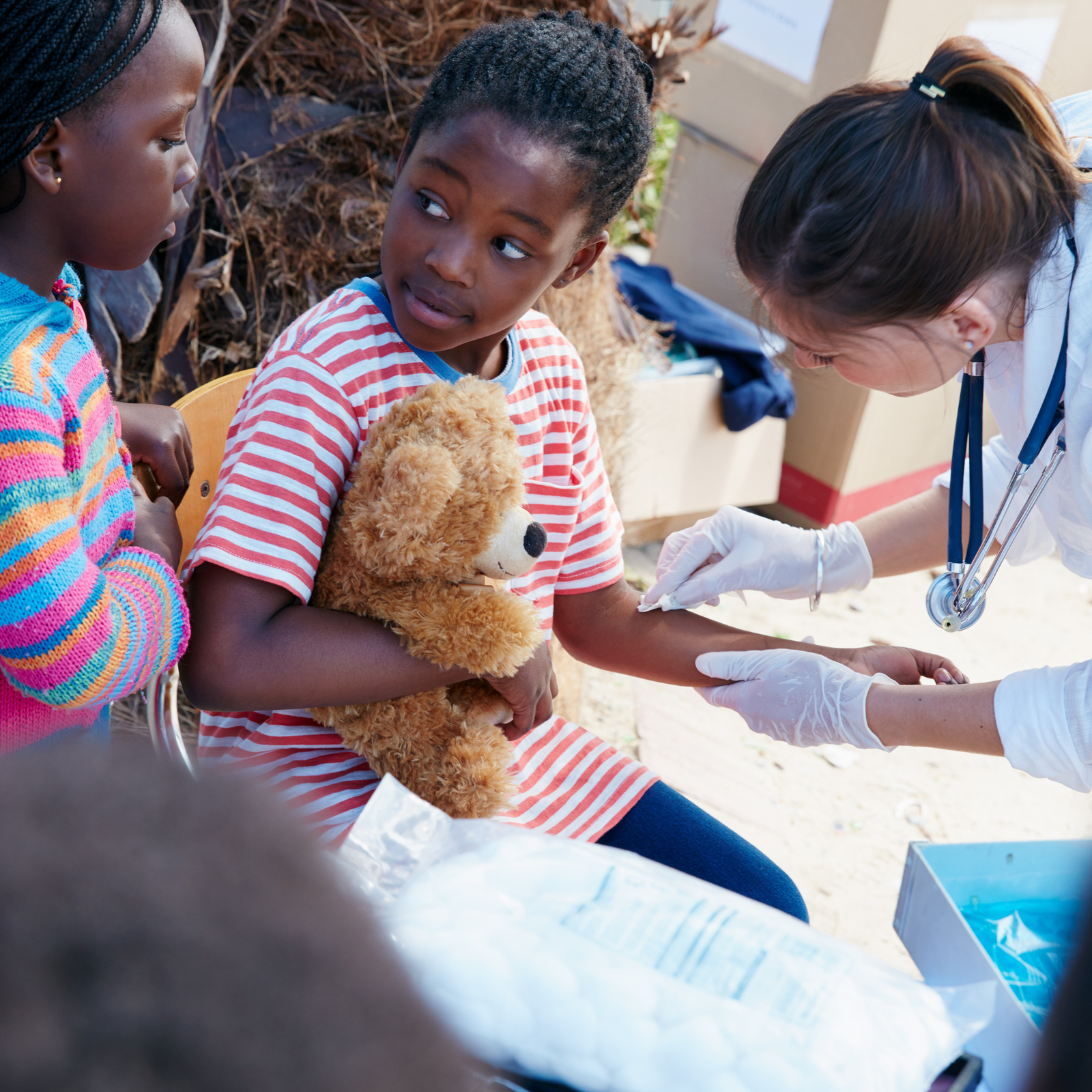 Volunteers handling a food donation box at a community event